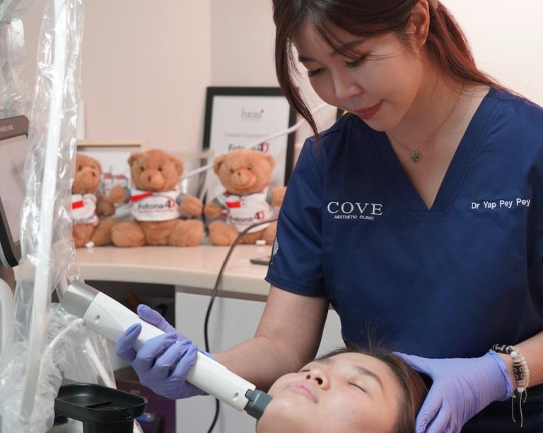 Doctor performing radiofrequency skin tightening treatment on a patient.